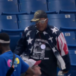 Watch this fan in an American flag jacket snag a foul ball and dance ridiculously